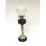 A Hinks late Victorian brass oil lamp the stem in the form of intertwined putti. With a ruby glass