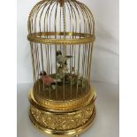An Reuge music box in the form of a singing bird in a cadge.