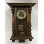 A wooden cased wall clock with brass dial.Approx 60cm - NO RESERVE