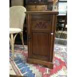 A Edwardian mahogany pot cupboard with single door on bracket feet .