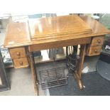 A Singer oak cased treadle sewing machine.