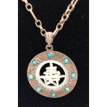 A 9ct gold turquoise and mother of pearl pendant on a 9ct gold chain. (Approx 15.8g)