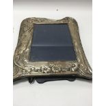 An Art Nouveau style sliver photo frame with stylised design London 1991, photo size 15 by 20 cm -