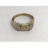 A gents 9ct gold buckle ring set with diamonds, approx 4g and approx size V.