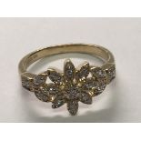 A 9carat gold ring set with a floral pattern of diamonds. ring size M-N