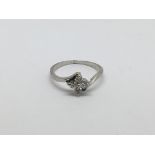 An 18ct white gold ring set with four diamonds in a rose setting, approx 1/2ct, approx 2.1g and