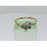 A circa 1930s 18ct gold and platinum three stone diamond ring, approx 2.5g and approx size R.