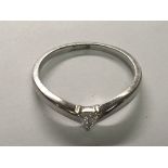 An 18carat white gold ring set with a triangular diamond. ring size Q.