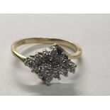 An 18carat gold ring set with a cluster of diamonds ring size H.
