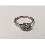A white gold ring set with a cluster of brilliant cut diamonds ring size S.