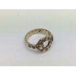 A 9ct weave design ring set with diamonds. Approx 2.8g. (G).