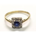 An 18carat gold ring set with a blue sapphire and diamonds in a square setting. Ring size R.