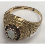 A 1980s 9ct gold opal and garnet ring (Approx 3g) ring size M.5.