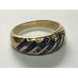 An 18carat gold ring set with a pattern of blue sapphire and diamonds. ring size M.