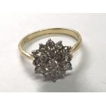 An 18carat gold diamond cluster ring set with a pattern of brilliant cut diamonds.