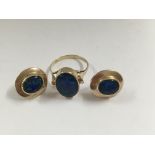 A 9 ct gold ring and a pair of matching earrings