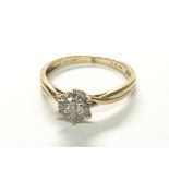 An 18carat gold ring set with a cluster of diamonds approximately 0.25 of a carat ring size O.