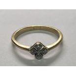 An 18carat gold ring set with a pattern of four diamonds. Ring size N.