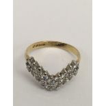An 18ct gold, 'V' shape diamond cluster ring, consisting of 18x.5pt stones.Approx 3.28, O.