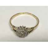 A 9carat gold ring set with a cluster of diamonds 0.10 of a carat ring size O-P