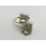 A 14ct gold ring set with three diamonds and mother of pearl, approx 5.5g and approx size Q.