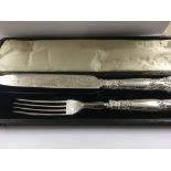 A cased silver handle knife and fork and two set of tea spoons.