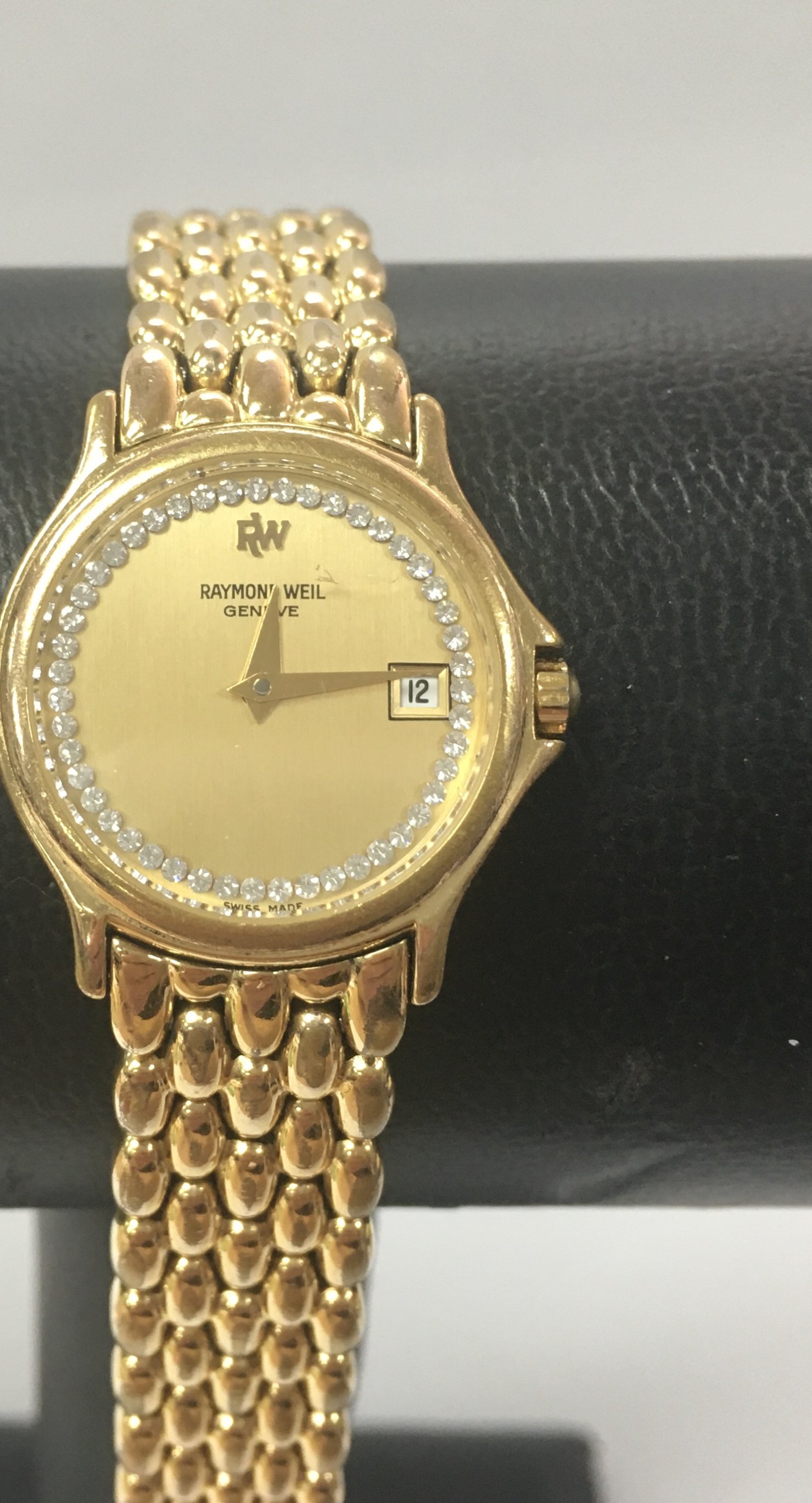 A Raymond Weil gold plated ladies day date watch.