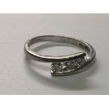 A modern design 9carat white gold ring set with three brilliant cut diamonds. ring size J.