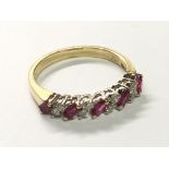 An 18carat gold ring set with an alternating pattern of Ruby’s and diamonds ring size L.