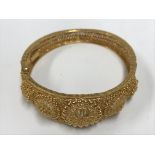 A heavy 22ct gold Indian bracelet, marked 22k. Approx 34g.