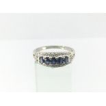 A ladies 9ct white gold ring set with diamonds and five sapphires, approx 3.6g and approx size S.