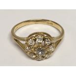 An 18carat gold ring set with a cluster of rose cut diamonds. ring size P.