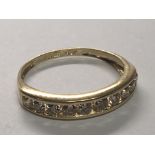 An 18cart gold ring set with a row of ten brilliant cut diamonds. Ring size M.