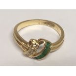 An 18carat gold ring set with green Emralds baguettes and diamonds ring size G.