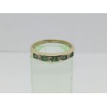 A 9ct gold half eternity ring set with alternating emeralds and diamonds, approx 1.8g and approx