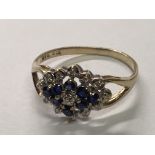 A gold ring set with blue sapphire and diamonds. ring size Q.