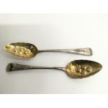 A pair of Georgian silver gilt berry spoons