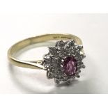 An 18 carat gold ruby and diamond cluster ring size O.