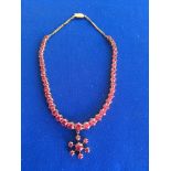 An unmarked but tested high ct gold and pink zircon set necklace. ( overall weight 39g)