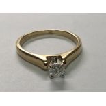 A 10 carat yellow gold ring set with a solitaire brilliant cut diamond. Ring size M.