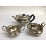 A silver three piece teaset with gadrooned edge, London hallmarks for Edward Barnard and Sons.Approx