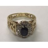 An 18carat gold ring set with a central oval blue sapphire flanked by a row of diamonds with a