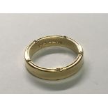 An unusual design 18carat gold ring set with diamonds to the top and lower edge. Ring Size M.