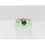 A 14ct white gold solitaire ring set with a sapphire, approx 1.8g and approx size O.
