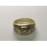 A Gents 18carat gold Gypsy type ring set with three diamonds 0.30 of a carat total weight 7.4g. Ring