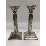 A pair of Corinthian column candlesticks, approx 21g. London hallmarks.