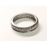 An 18carat white gold eternity ring set with a row of brilliant cut diamonds. Ring size J