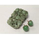 A pair of 18ct gold mounted Apple green jade studs plus a silver mounted carved jade brooch. (A/F).