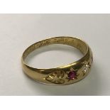 An 18carat gold ring set with alternating Ruby’s and diamonds ring Size S.