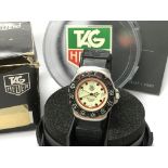 A Mid size Tag Heuer Quartz professional with rubber strap and original boxes.